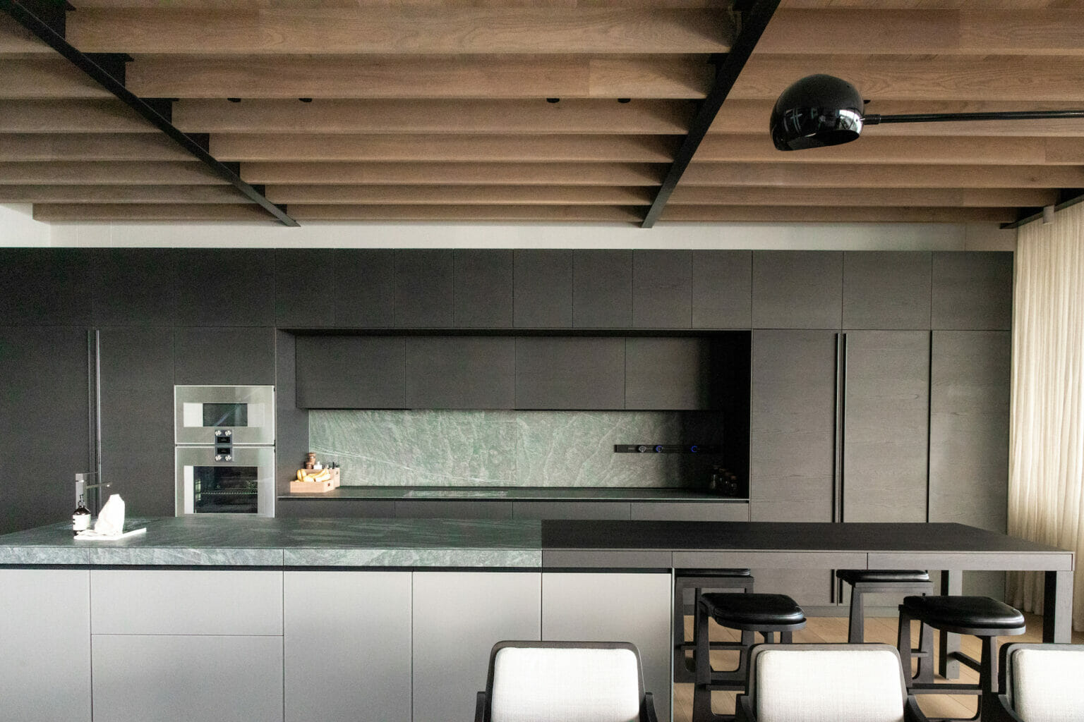 A textural combination of various stones, wood and glass bring the luxury kitchen to life